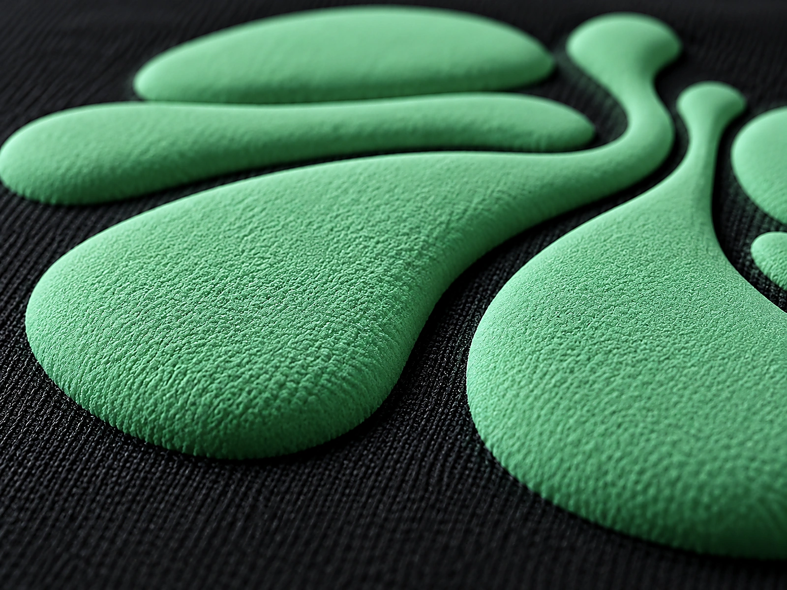 Macro close-up of raised puff-print texture on black fabric